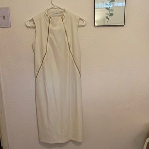 Calvin Klein white dress with zipper details on sides.